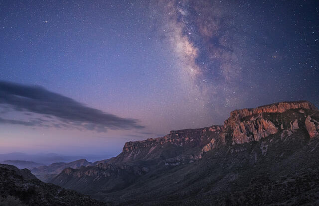 Milky Way rises above the southeastern wall of Juniper Canyon just as twilight begins to glow on the canyon walls.